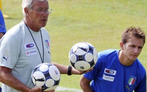 Italian national soccer team coach Marcello Lippi, left, speaks to player Domenico Criscito, during a practice session at the Coverciano training grounds, near Florence, central Italy, Tuesday Aug. 11, 2009. Italy is scheduled to play a friendly match against Switzerland in Basel, Wednesday Aug. 12, 2009, its first match since its disastrous showing at the Confed Cup in South Africa in June. (AP Photo/Lorenzo Galassi)