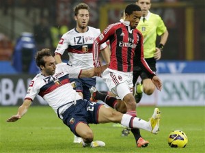 AC Milan midfielder Urby Emanuelson, right, of the Netherlands, is tackled by Genoa defender Emiliano Moretti during the Serie A soccer match between AC Milan and Genoa at the San Siro stadium in Milan, Italy, Saturday, Oct. 27, 2012. (AP Photo/Antonio Calanni)